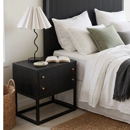Black bedside table featured in a modern bedroom setting