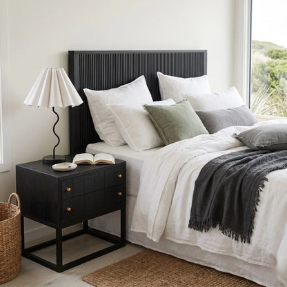 Black bedside table featured in a modern bedroom setting