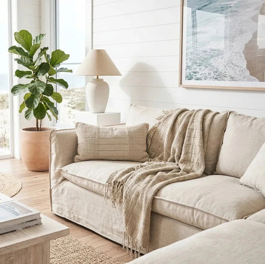 Cozy living room with beige sectional sofa, coffee table, and decorative elements.