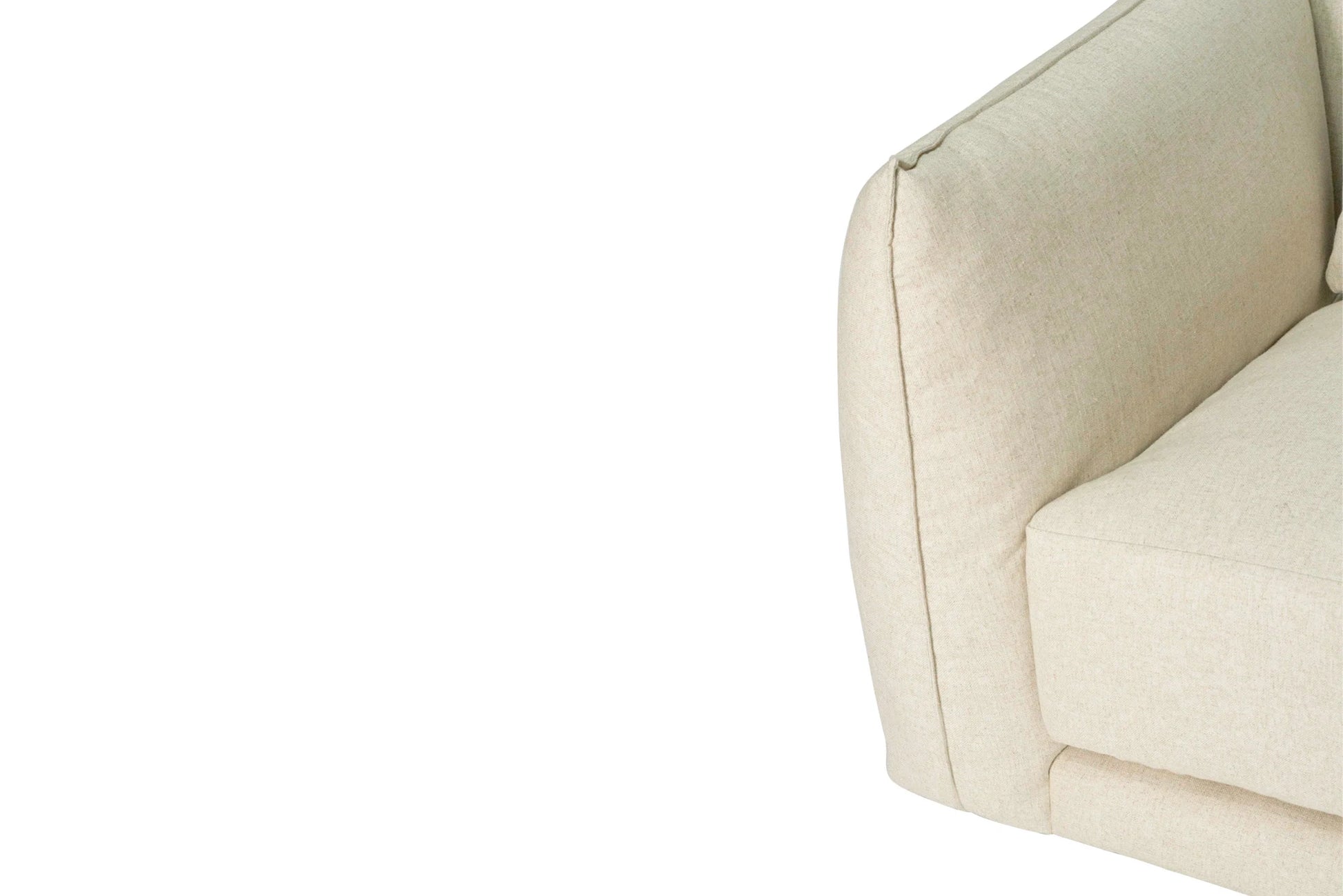 Close-up of a beige upholstered chair corner on a white background
