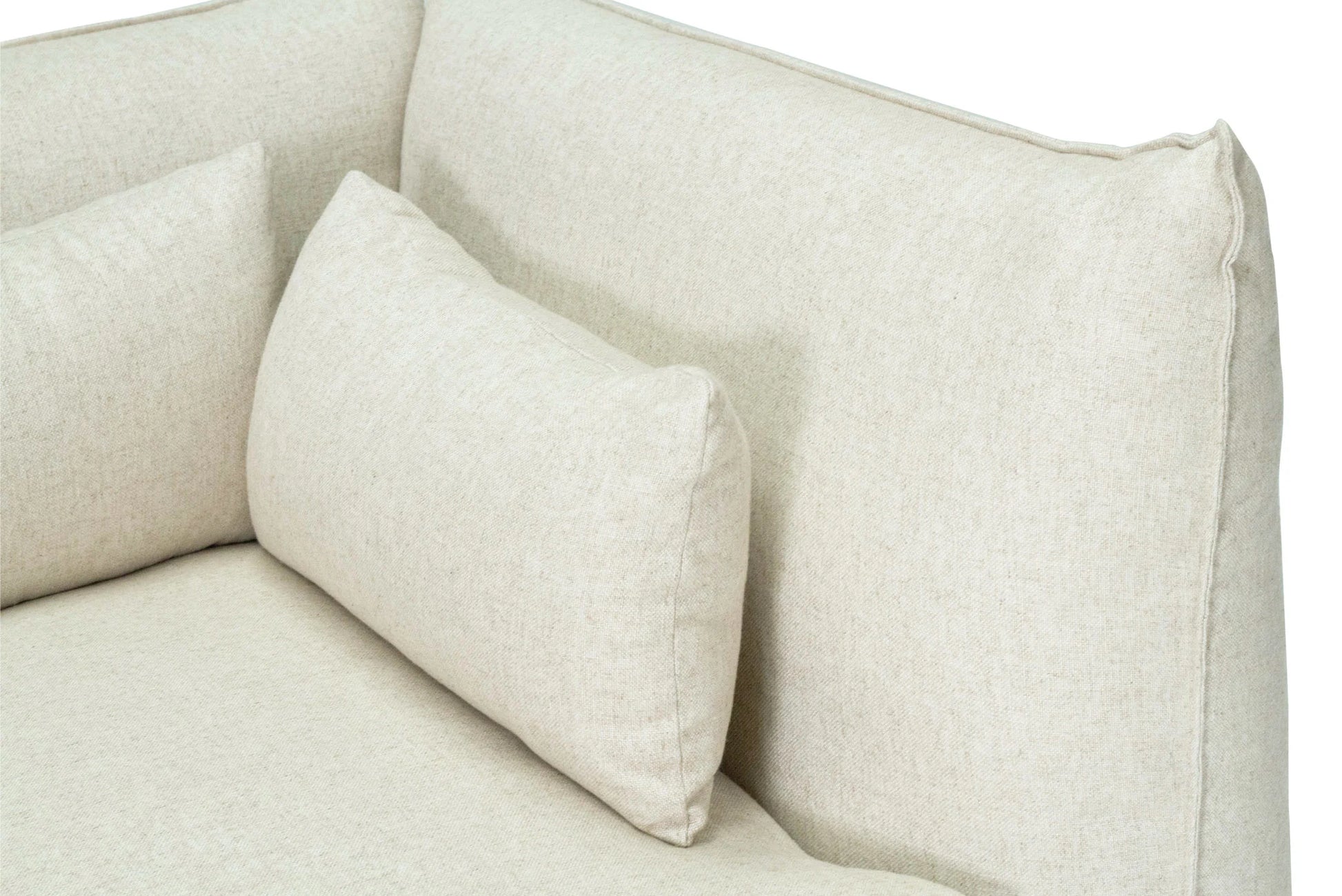Close-up of a beige sofa with cushions on a white background