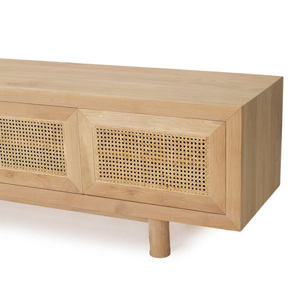 A close-up of a light natural wood media console or sideboard with two cane or rattan panel doors and a single visible leg, shown on a clean white background.