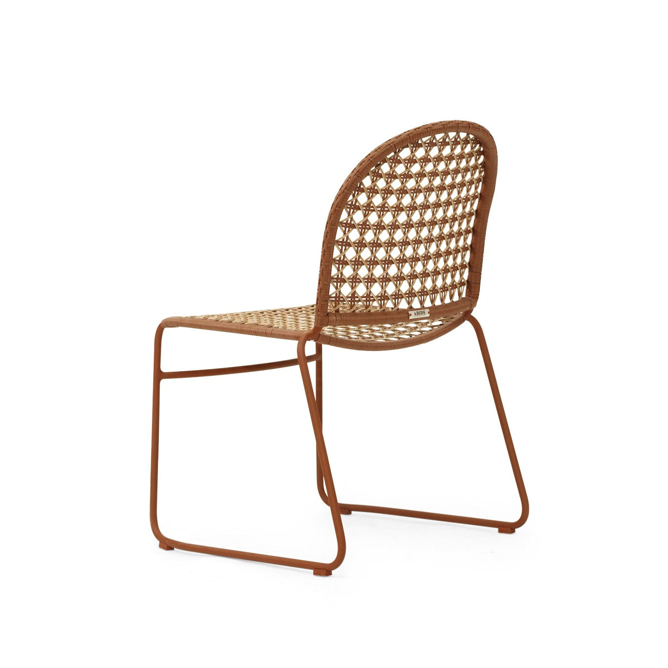 A modern side chair with a rust-brown metal frame and a woven cane seat and backrest, shown from a three-quarters angle on a white background.