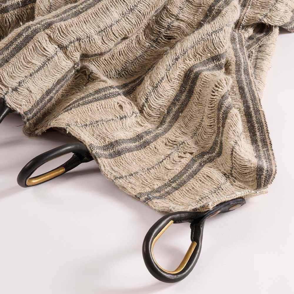 Textured curtains with black and gold hooks on a white background