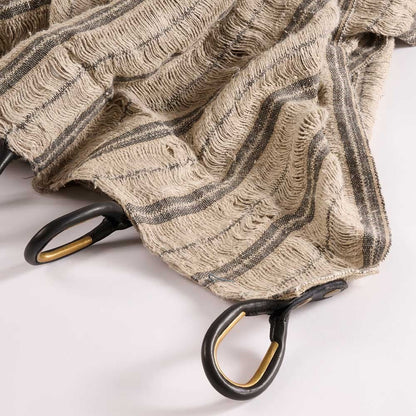 Textured curtains with black and gold hooks on a white background