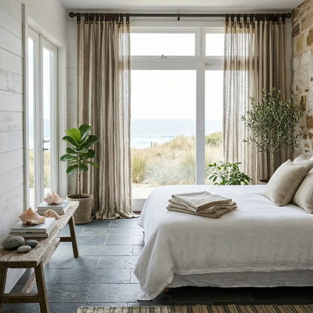 Cozy bedroom with a large window, bed, and decorative elements.