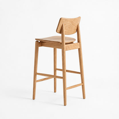 A light natural wood bar stool with a curved backrest, seat, and four legs, shown from a three-quarter angle against a plain white studio background.