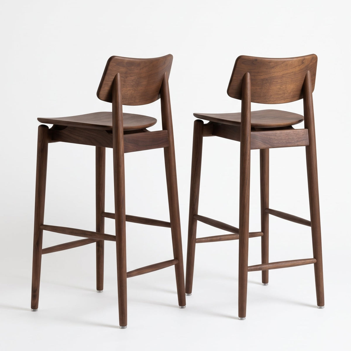 Two wooden bar stools with a dark walnut finish, shown from the back against a clean white studio background.