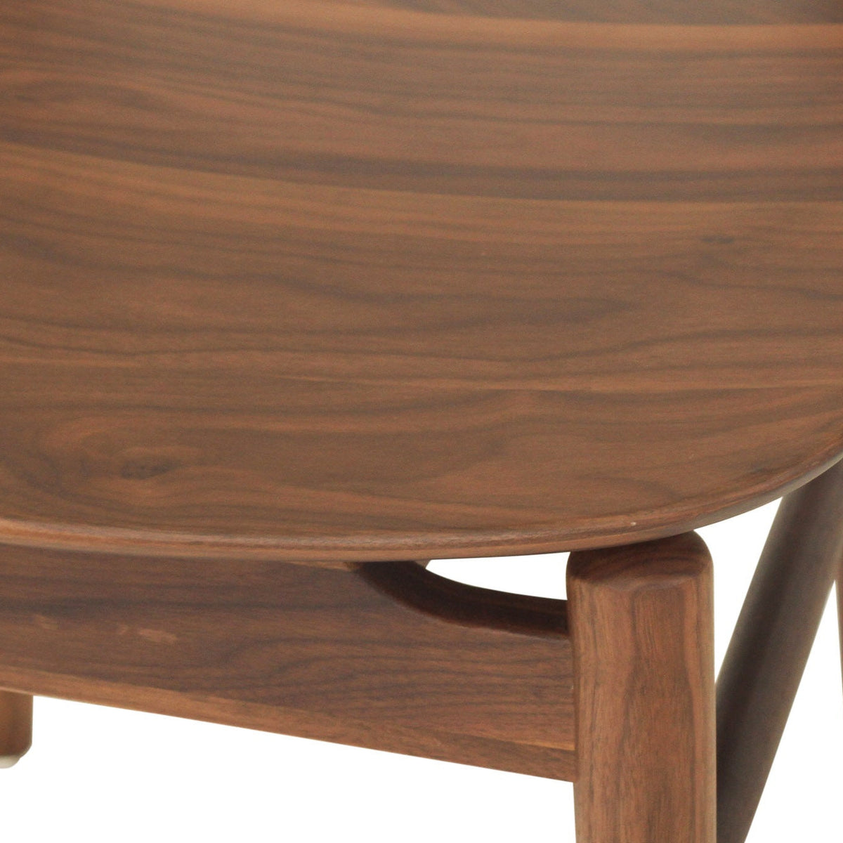 Close-up detail of a mid-century modern wooden chair with a rich walnut grain finish, showing the curved backrest and leg structure against a white background.