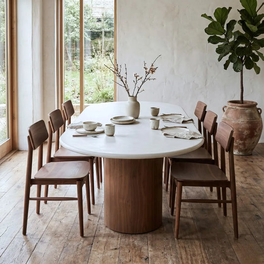 Dining area with a round table and wooden chairs.