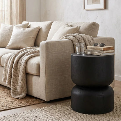 Modern living room with a sofa, and black stump side table.