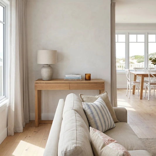 Living room with beige sofa, wooden side table, and lamp.