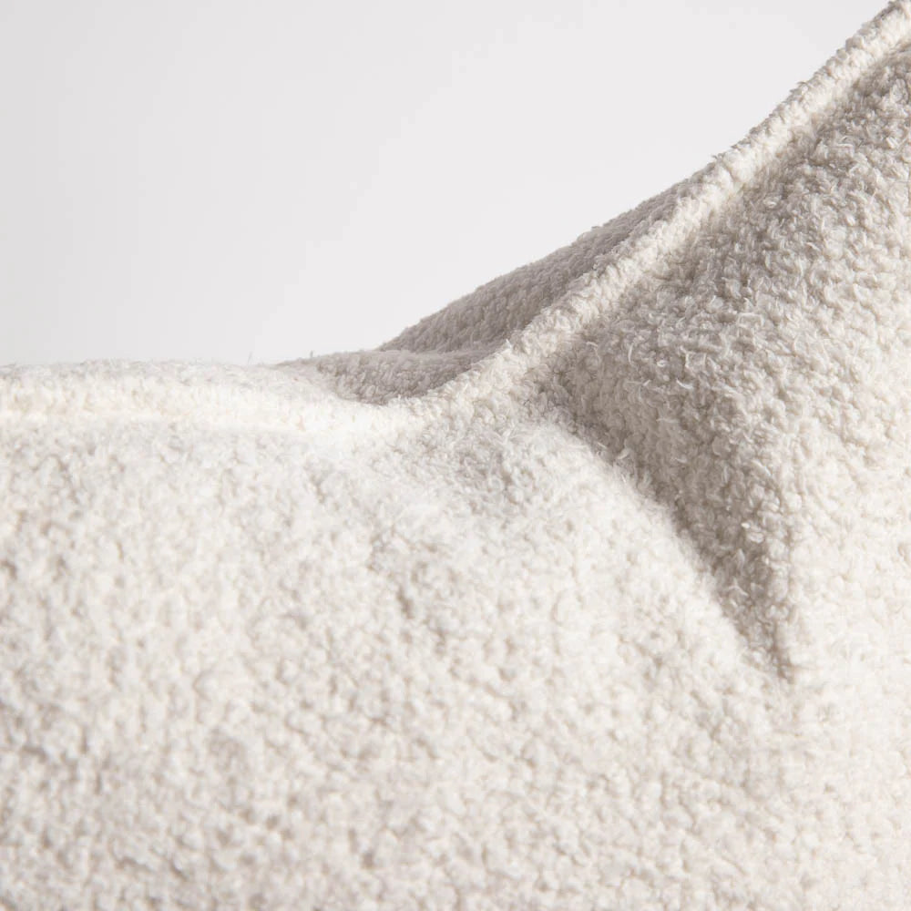 Close-up of textured fabric with a gradient from beige to gray.