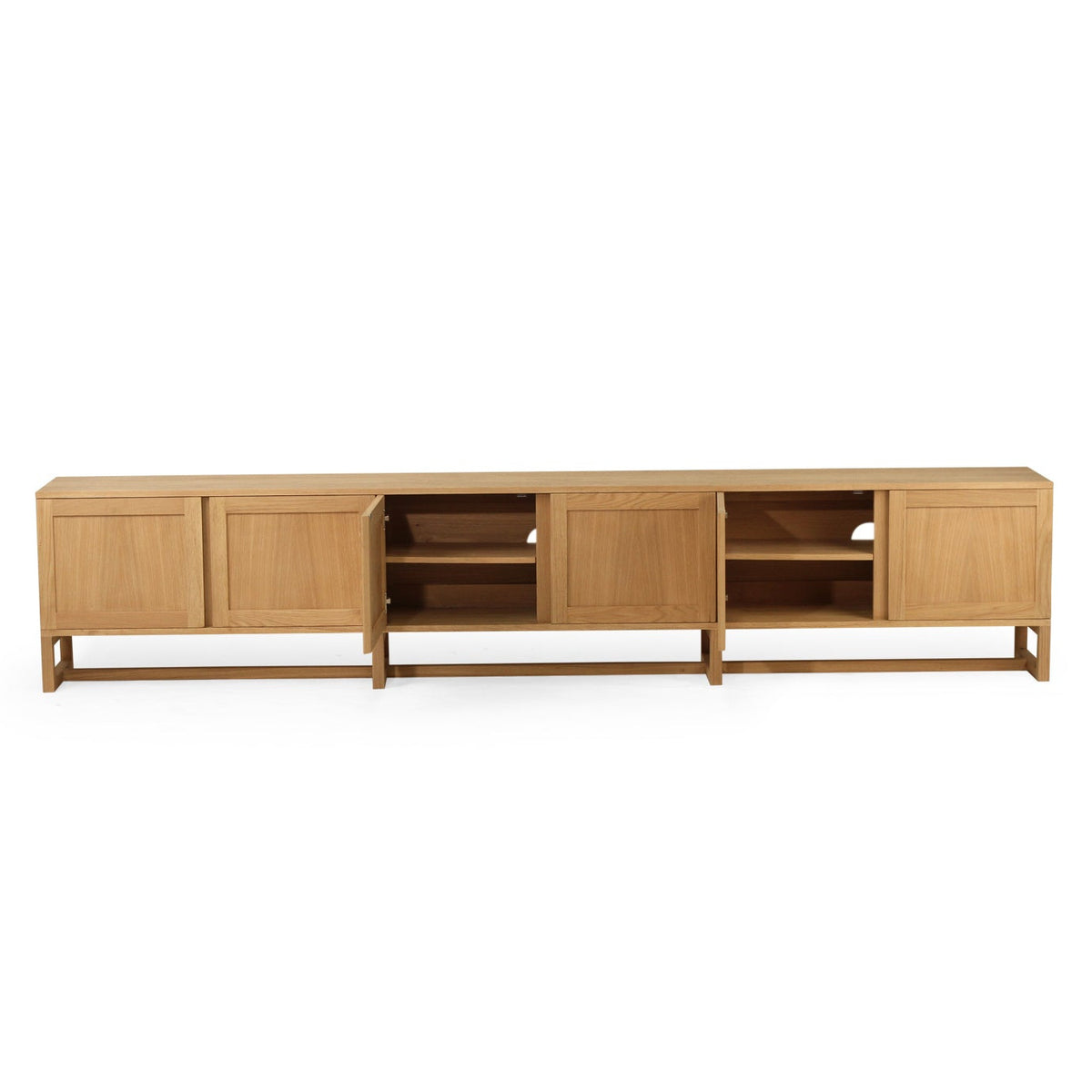 A long, low wooden media console or sideboard with a light natural oak finish, featuring four cabinet doors and open shelving sections, shown against a plain white background.