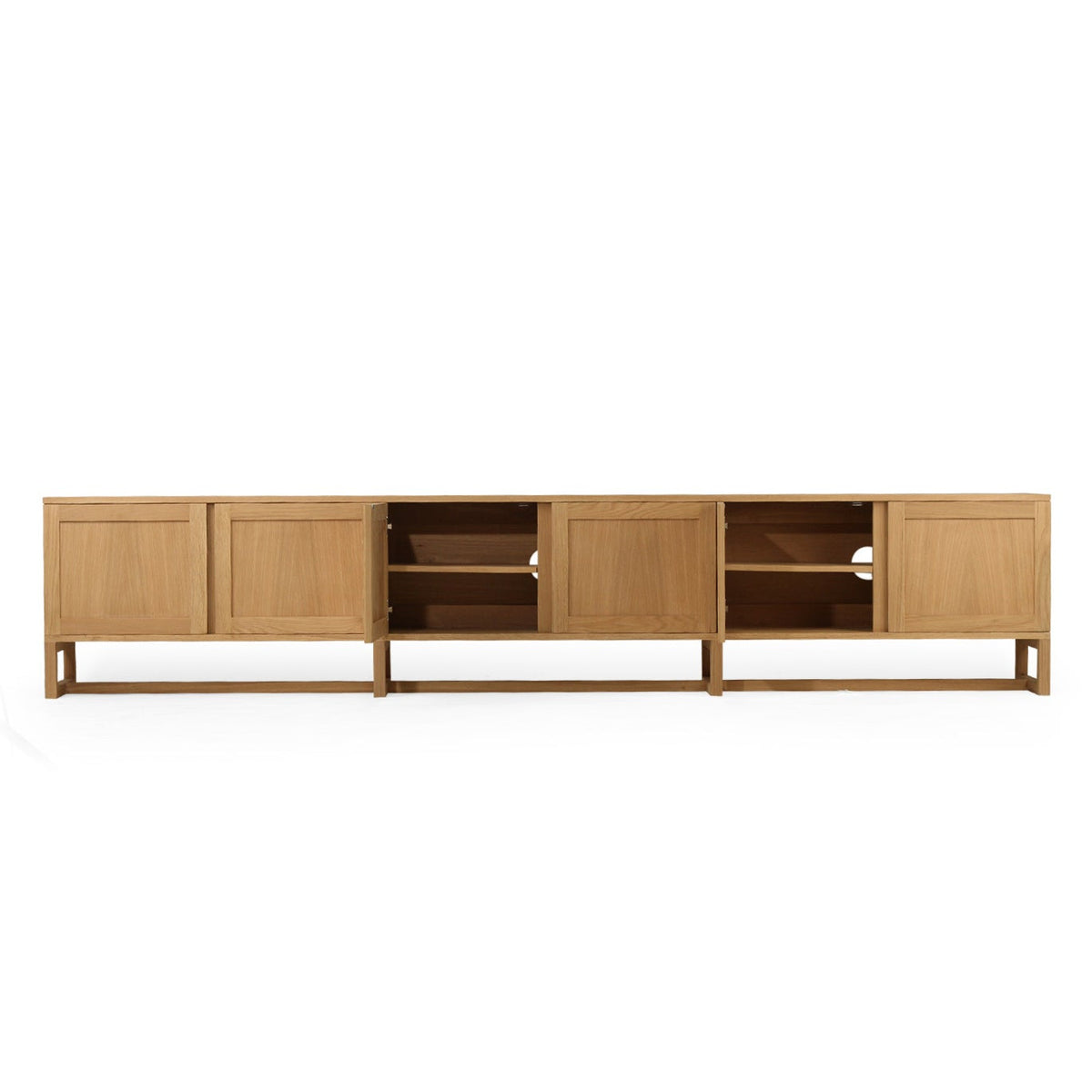 A modern light oak wood media console with a minimalist mid-century design, featuring paneled doors, open shelving, and a low open shelf, shown against a plain white background.