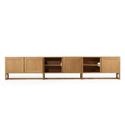 A modern light oak wood media console with a minimalist mid-century design, featuring paneled doors, open shelving, and a low open shelf, shown against a plain white background.
