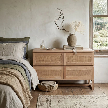 American Oak and rattan chest of drawers in a bedroom setting.
