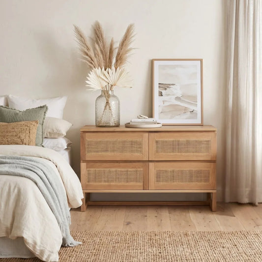 American Oak and rattan chest of drawers in a bedroom setting.