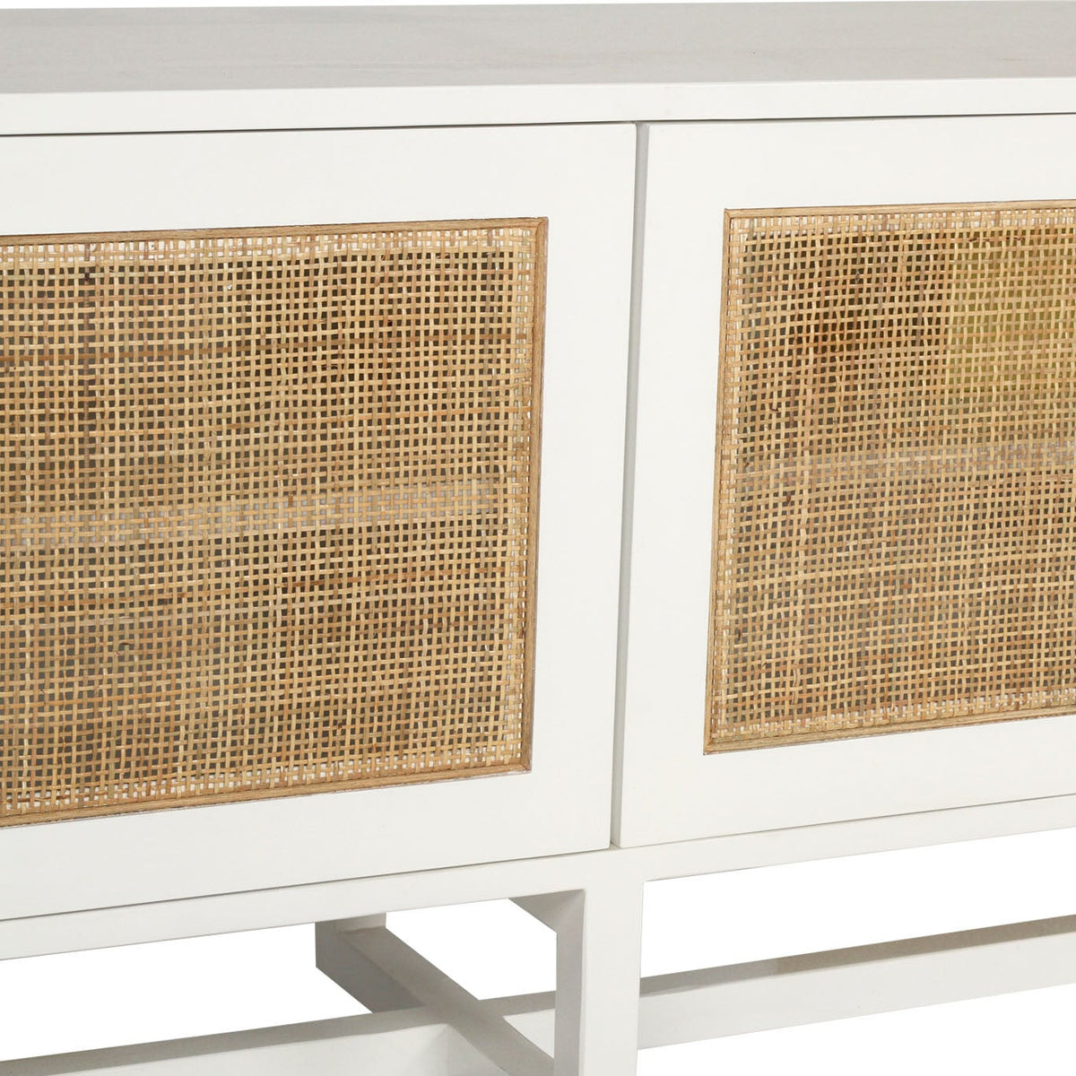 Close-up of a white cabinet or sideboard with woven cane or rattan panel inserts on the front.