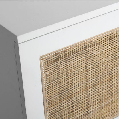Close-up of a white cabinet or shelf featuring a natural woven rattan or cane panel on the front door, shown against a plain white background.