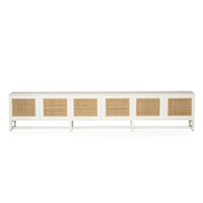 Product image of long white entertainment unit with six rectangular woven cane or rattan panels on the front, shown against a plain white background.