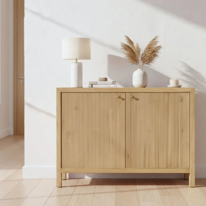 Light wooden sideboard with decorative items in a minimalistic room.