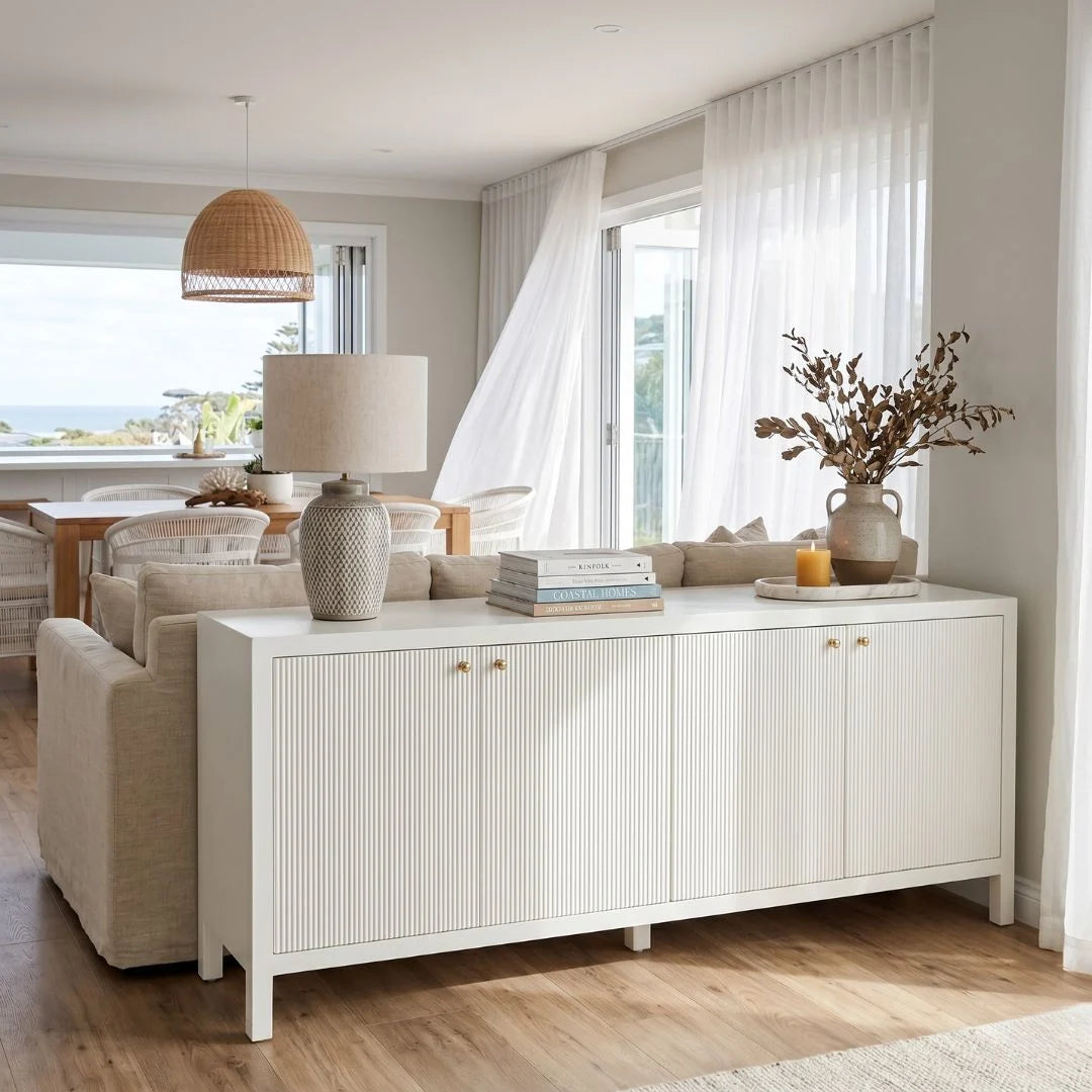 Living room with a white sideboard, sofa, and decorative items.