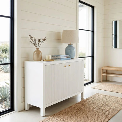White sideboard with decorative items in a modern living room