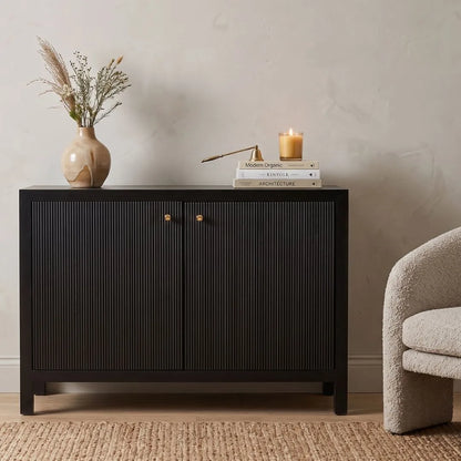 Black cabinet with decorative items on a beige wall background