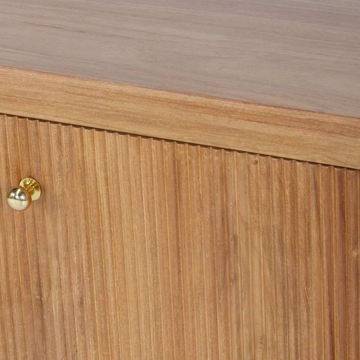 Close-up of a wooden cabinet with two doors, featuring vertical grain texture and round brass knobs.