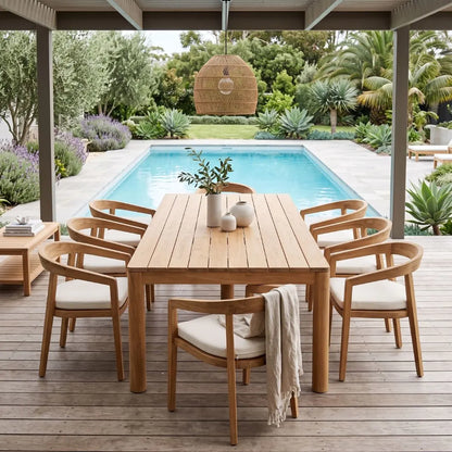 Wooden outdoor dining set with chairs and table near a pool
