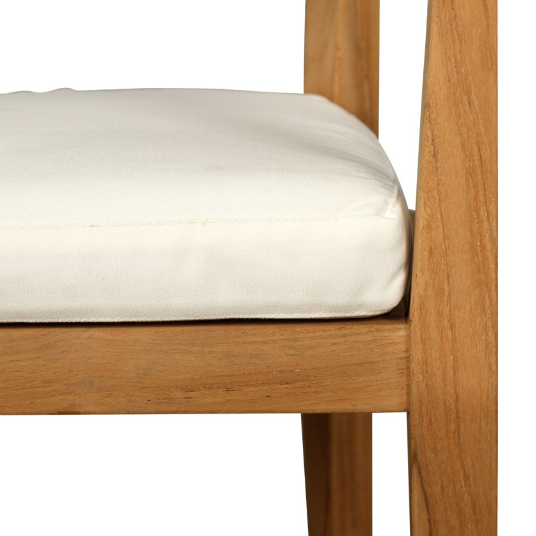 Wooden chair with a white cushion on a white background