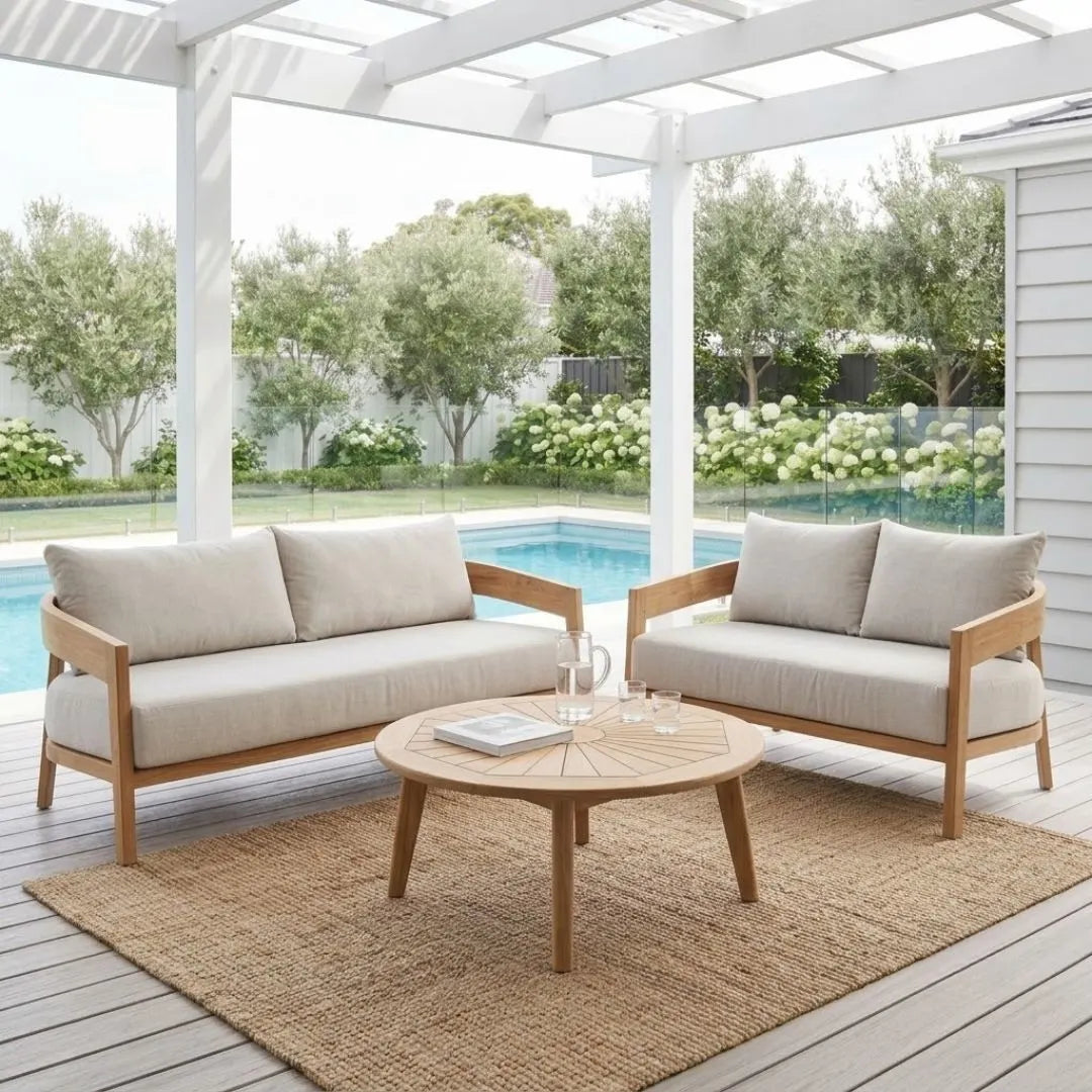Outdoor patio set with two sofas and a coffee table on a wooden deck.