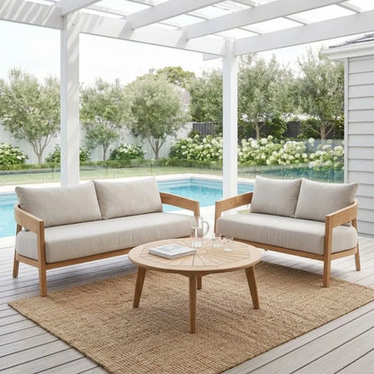 Outdoor patio set with two sofas and a coffee table on a wooden deck.