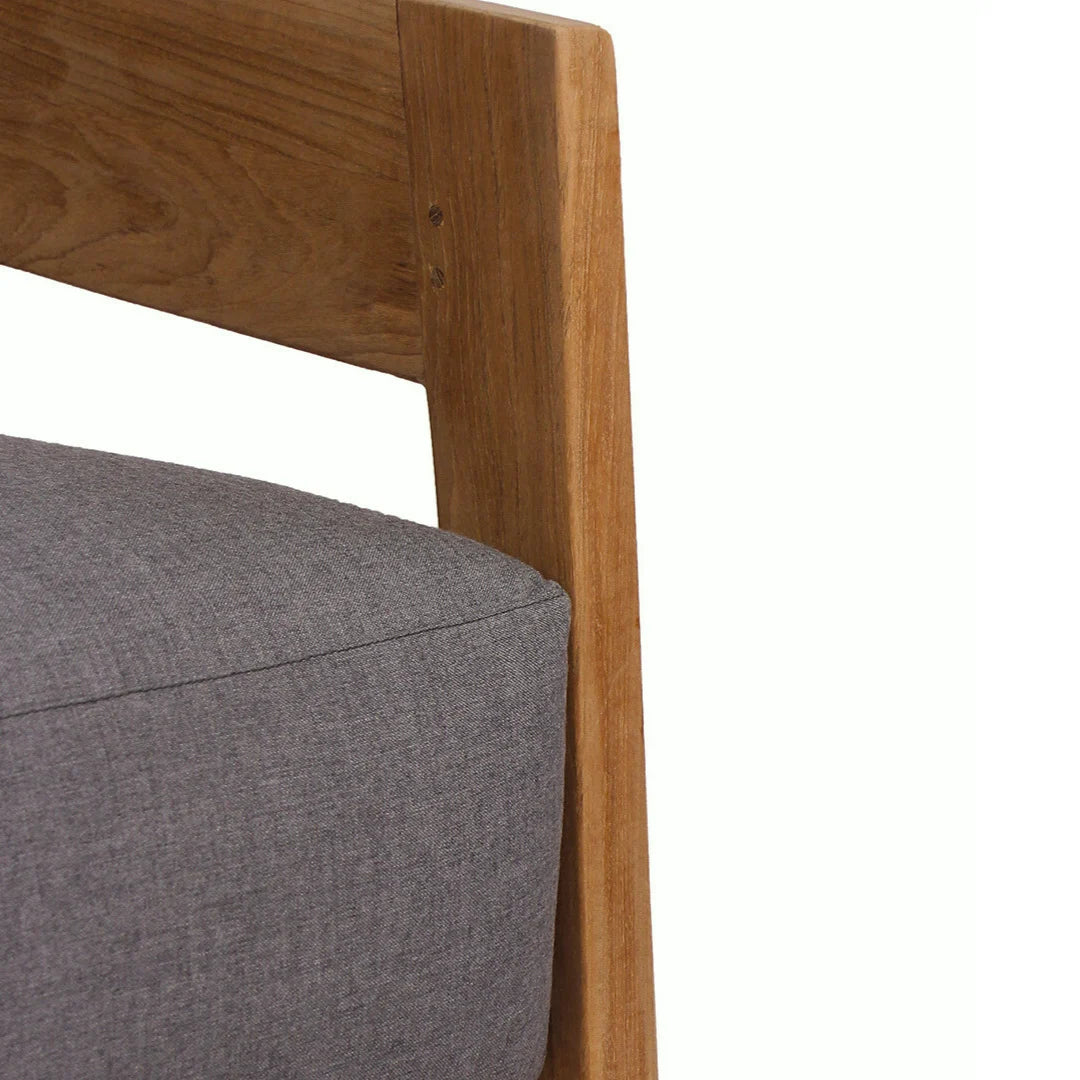 Gray cushioned chair with wooden armrest on a white background
