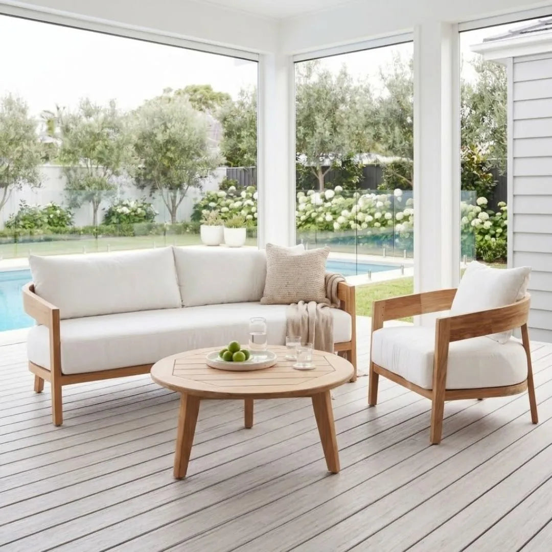 Outdoor furniture set with a sofa, chair, and coffee table on a wooden deck.