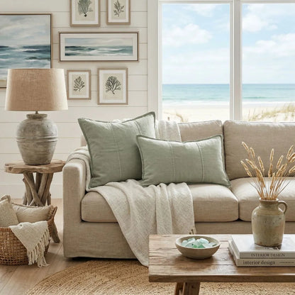 Cozy living room with beach-themed decor, including a sofa, lamp, and wall art.