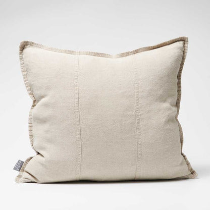 Beige pillow with brown trim on a white background