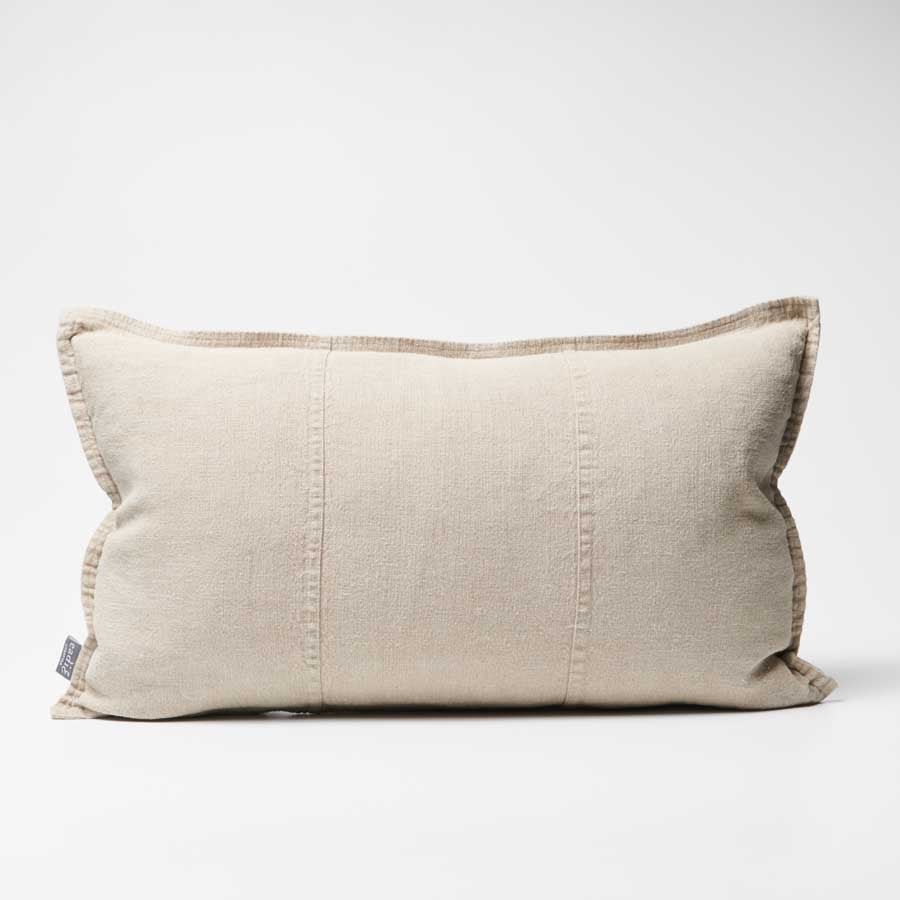 Beige pillow with a subtle texture on a white background
