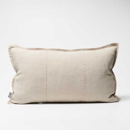 Beige pillow with a subtle texture on a white background