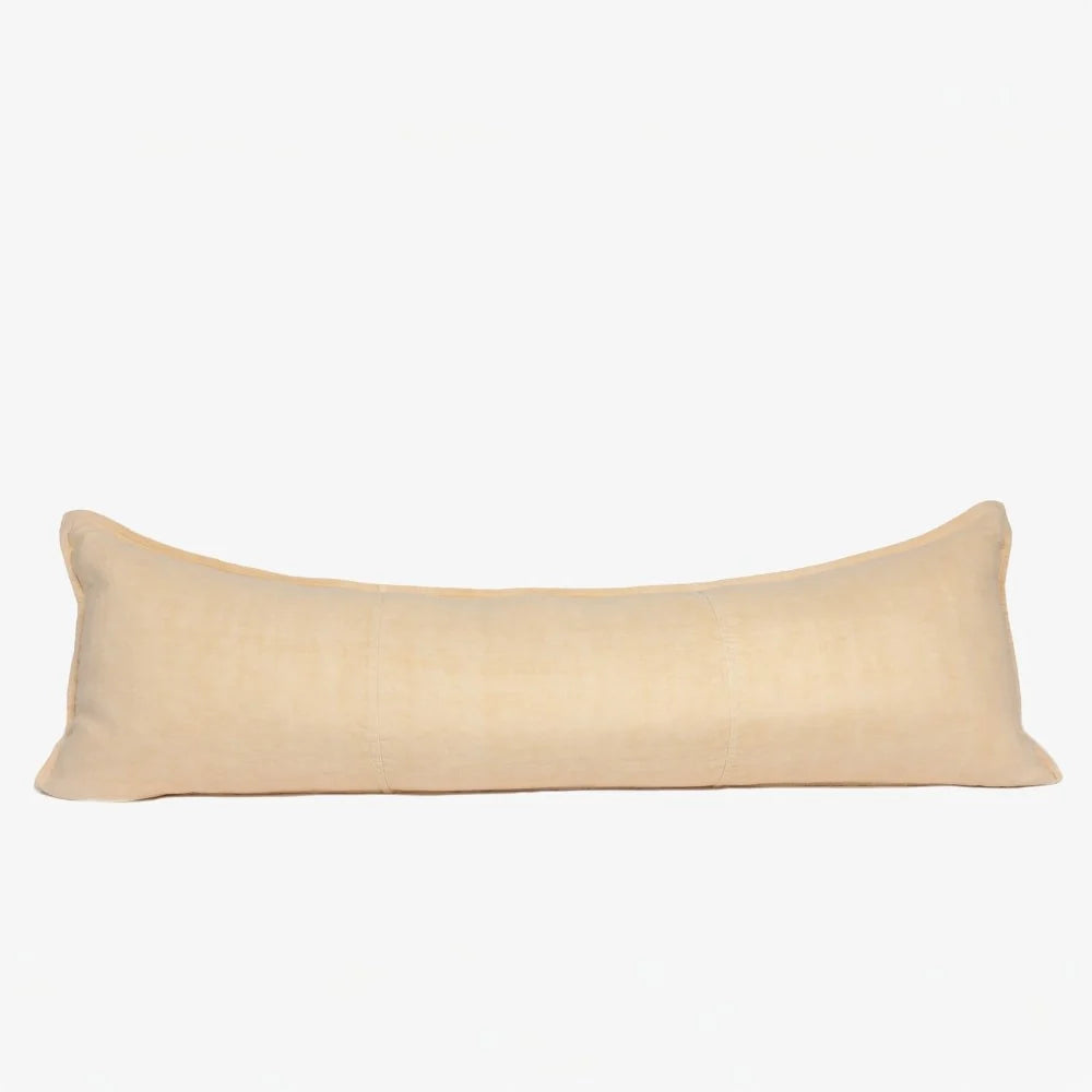 A long rectangular lumbar pillow in a light beige linen fabric, shown against a plain white background.