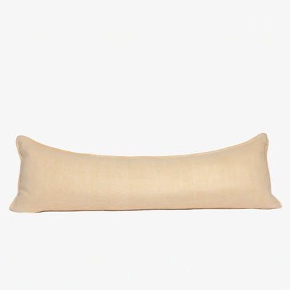 A long rectangular lumbar pillow in a light beige linen fabric, shown against a plain white background.