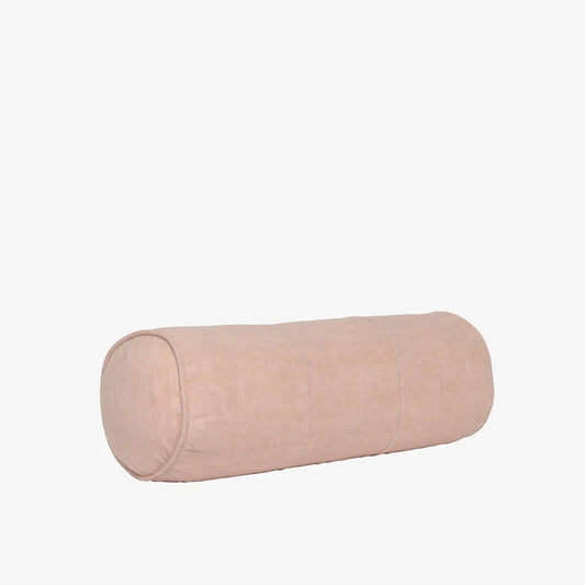 A cylindrical lumbar pillow in a light blush pink fabric, shown horizontally against a plain white background.