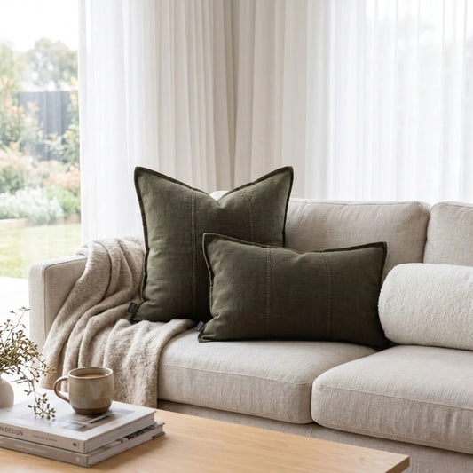 Beige sofa with brown cushions in a bright living room