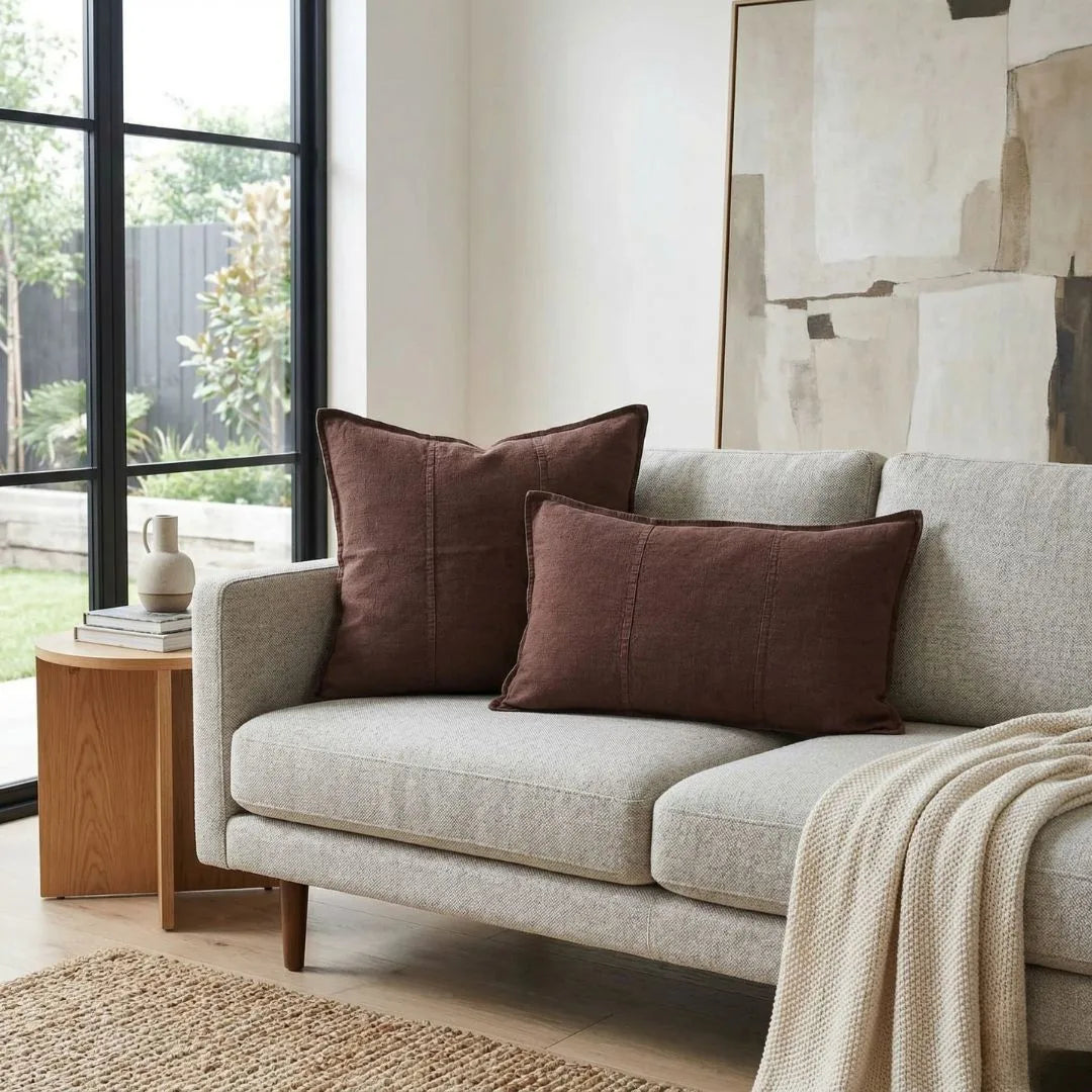 Gray sofa with brown cushions in a living room setting