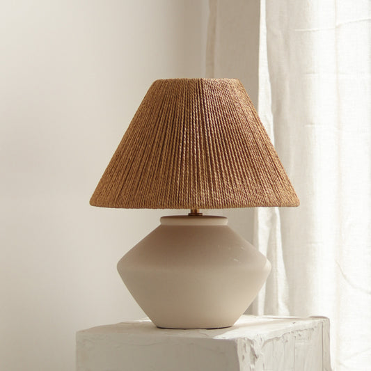 Table lamp with a textured brown shade on a neutral background