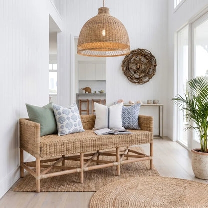 Wicker bench with cushions in a bright room with natural light