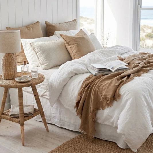 Cozy bedroom with a bed, side table, and lamp.