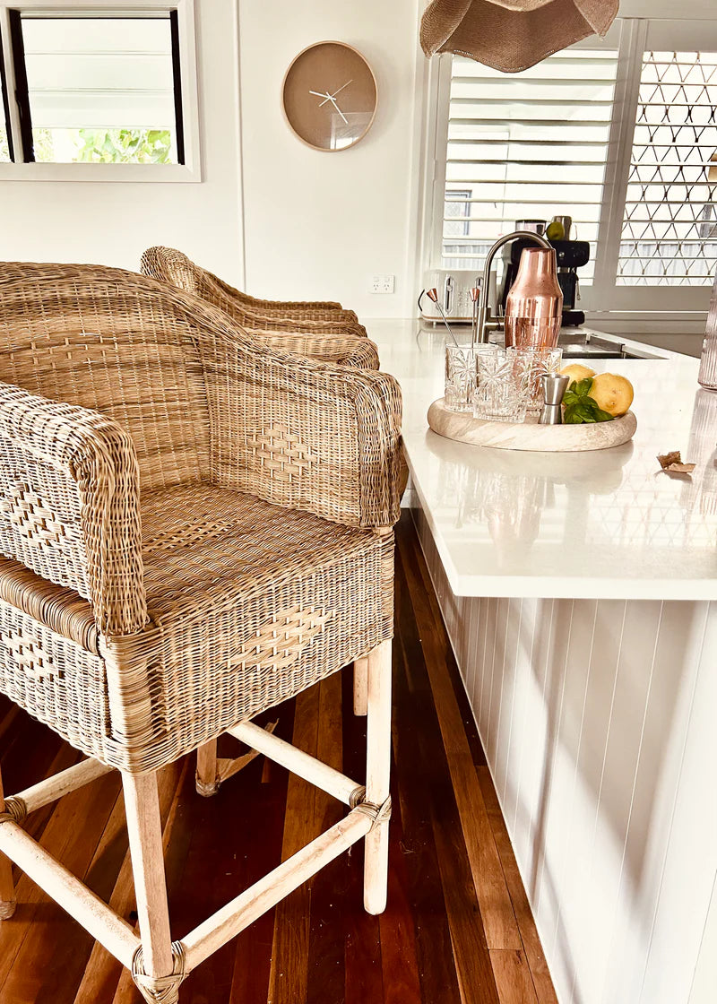 Malawi Cane stools in a kitchen with a white countertop and window blinds.