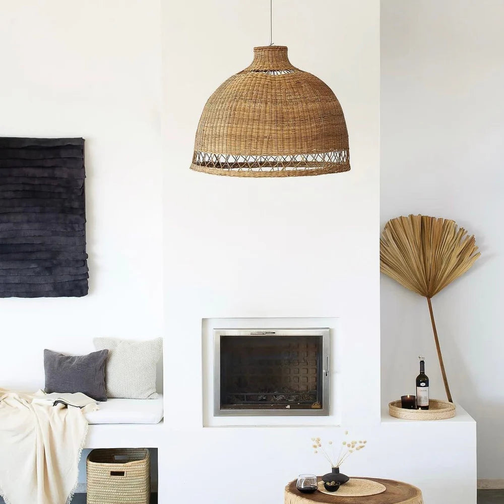 Living room with a wicker pendant lamp, fireplace, and decorative items.
